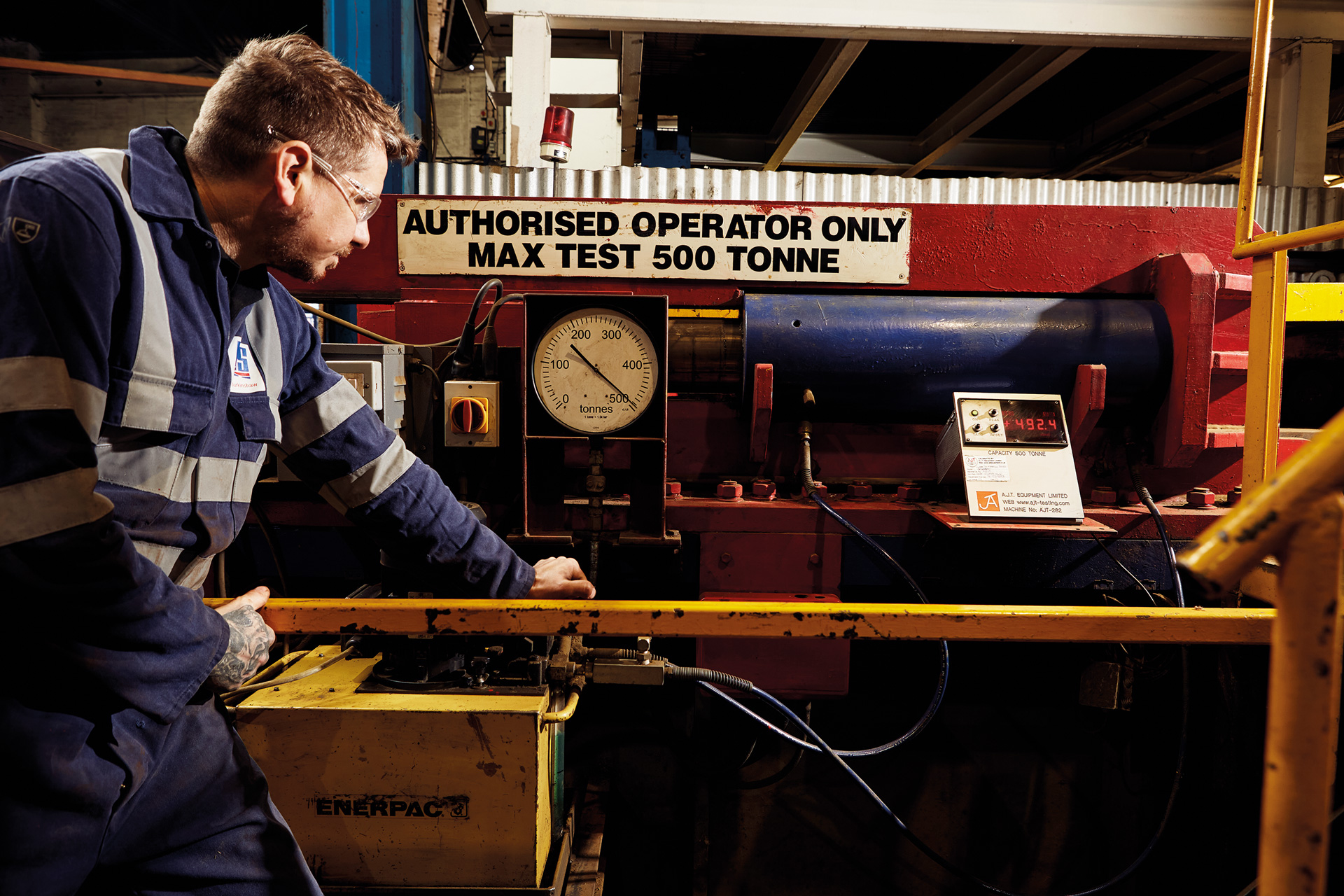 Operator performing proof load testing on ladle hook.